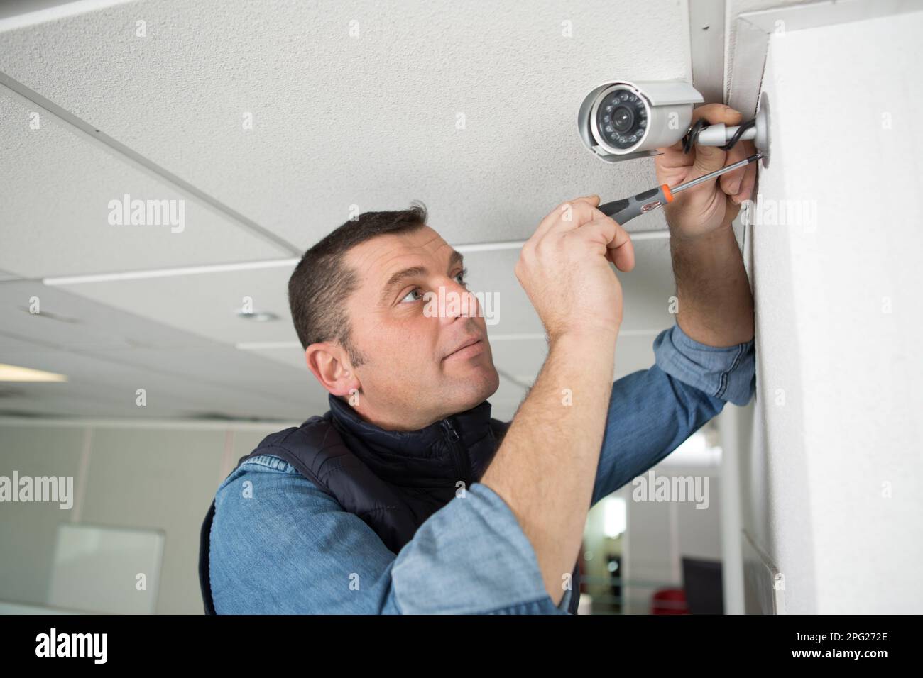 technician or contractor with cctv security camera Stock Photo