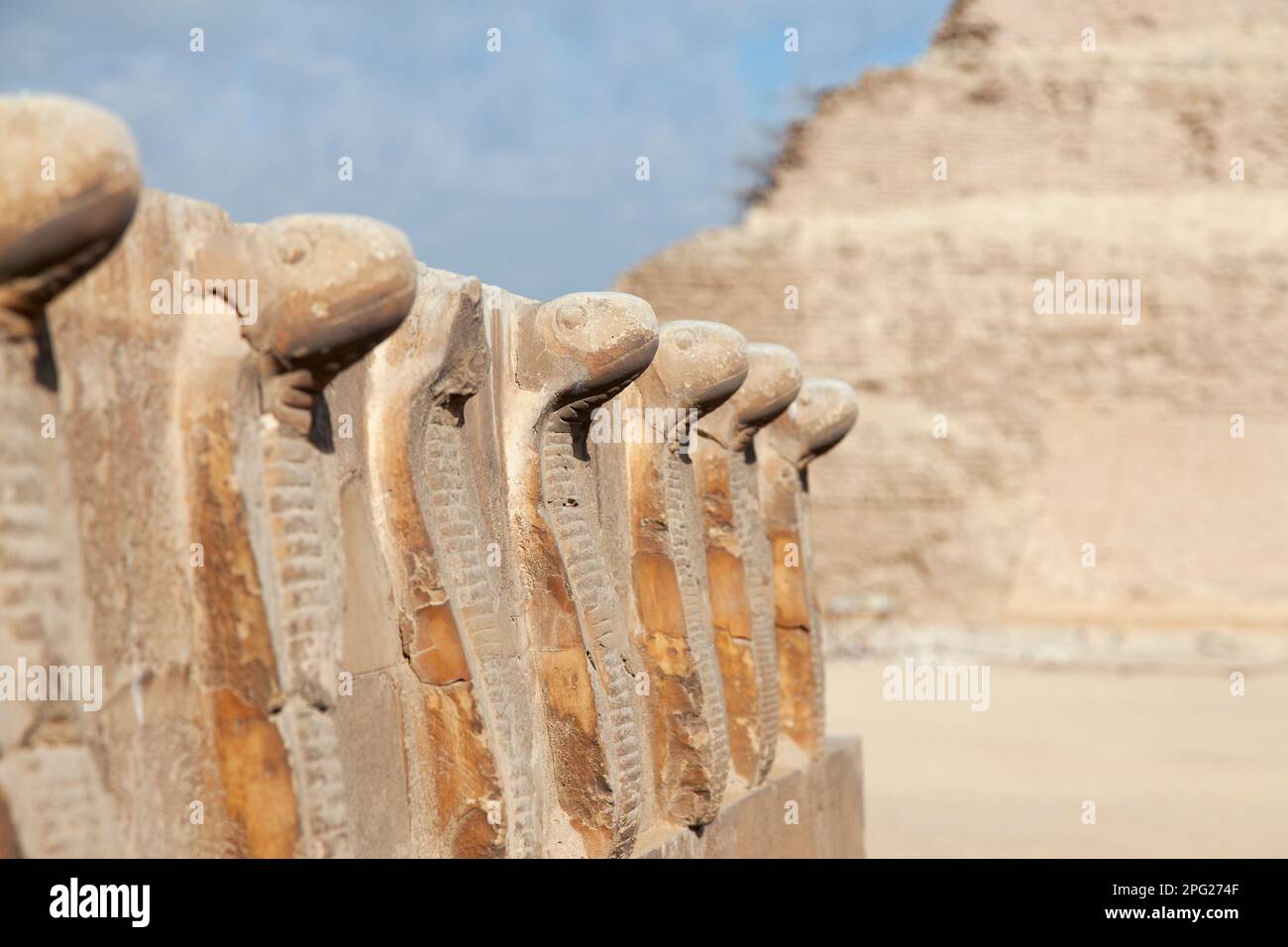 Egypt, Saqqara, snake statues with the stepped pyramid in the