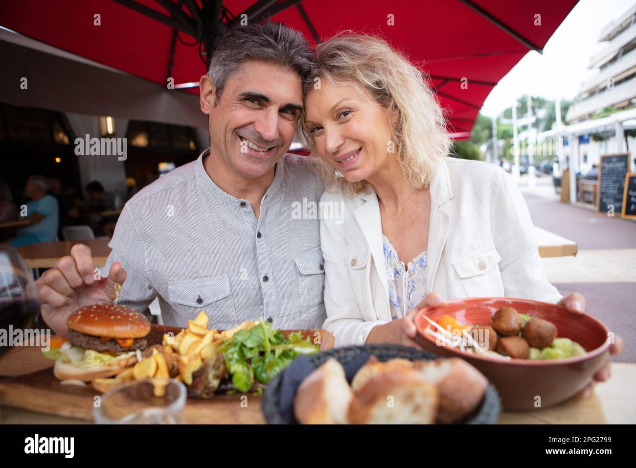 senior happy couple eating outdoors Stock Photo