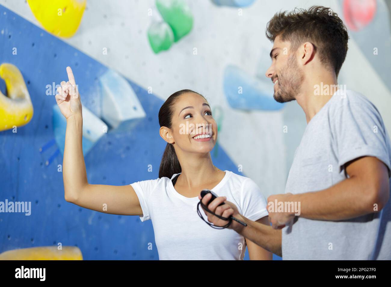 climber talking to instructor beside indoor climbing wall Stock Photo ...