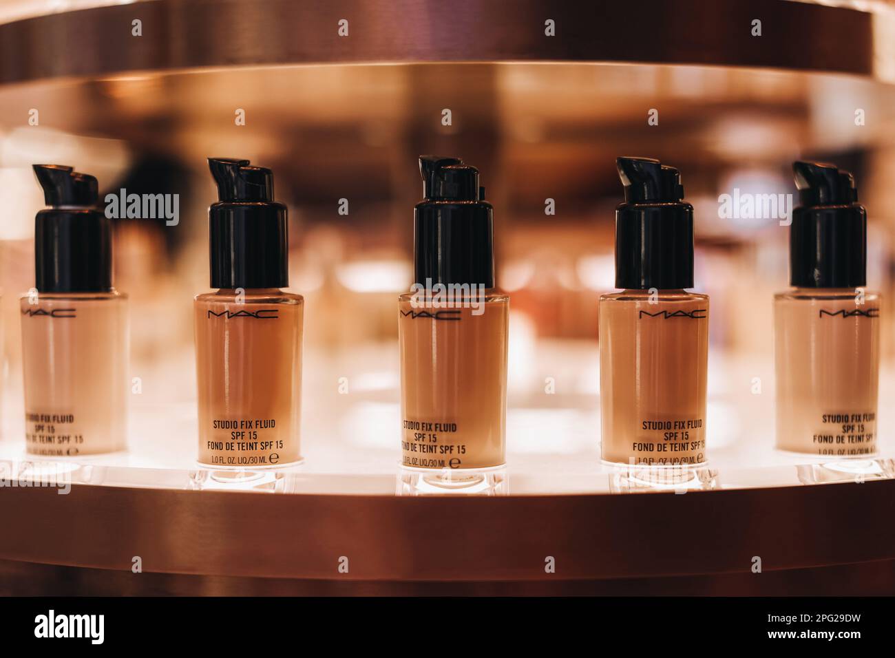 Glass tubes of Mac beige foundation on a stand in a store. The concept of decorative cosmetics for the face Stock Photo