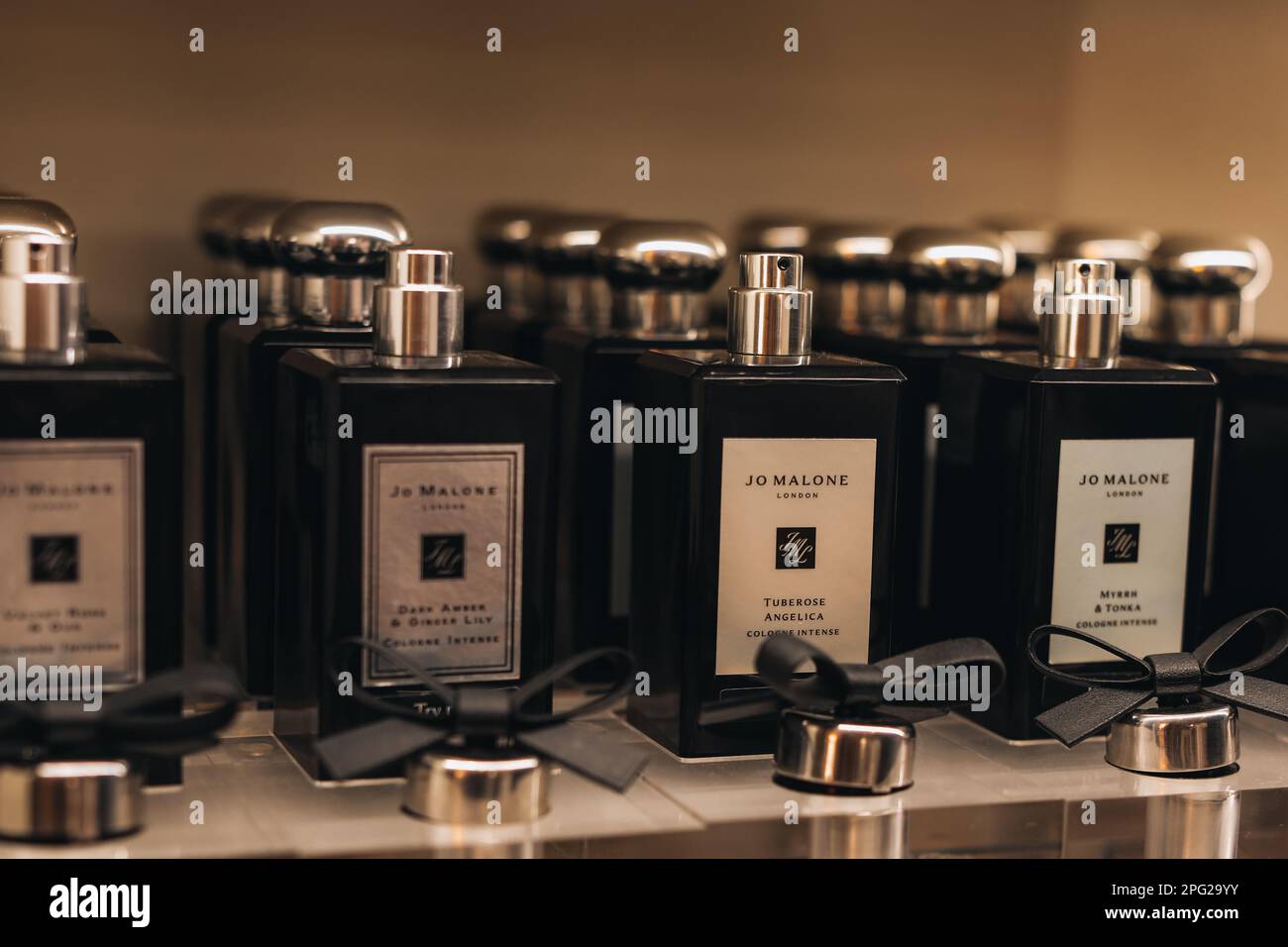 Glass black bottles of Jo Malone luxury perfume on a stand. Jo Malone London is a British