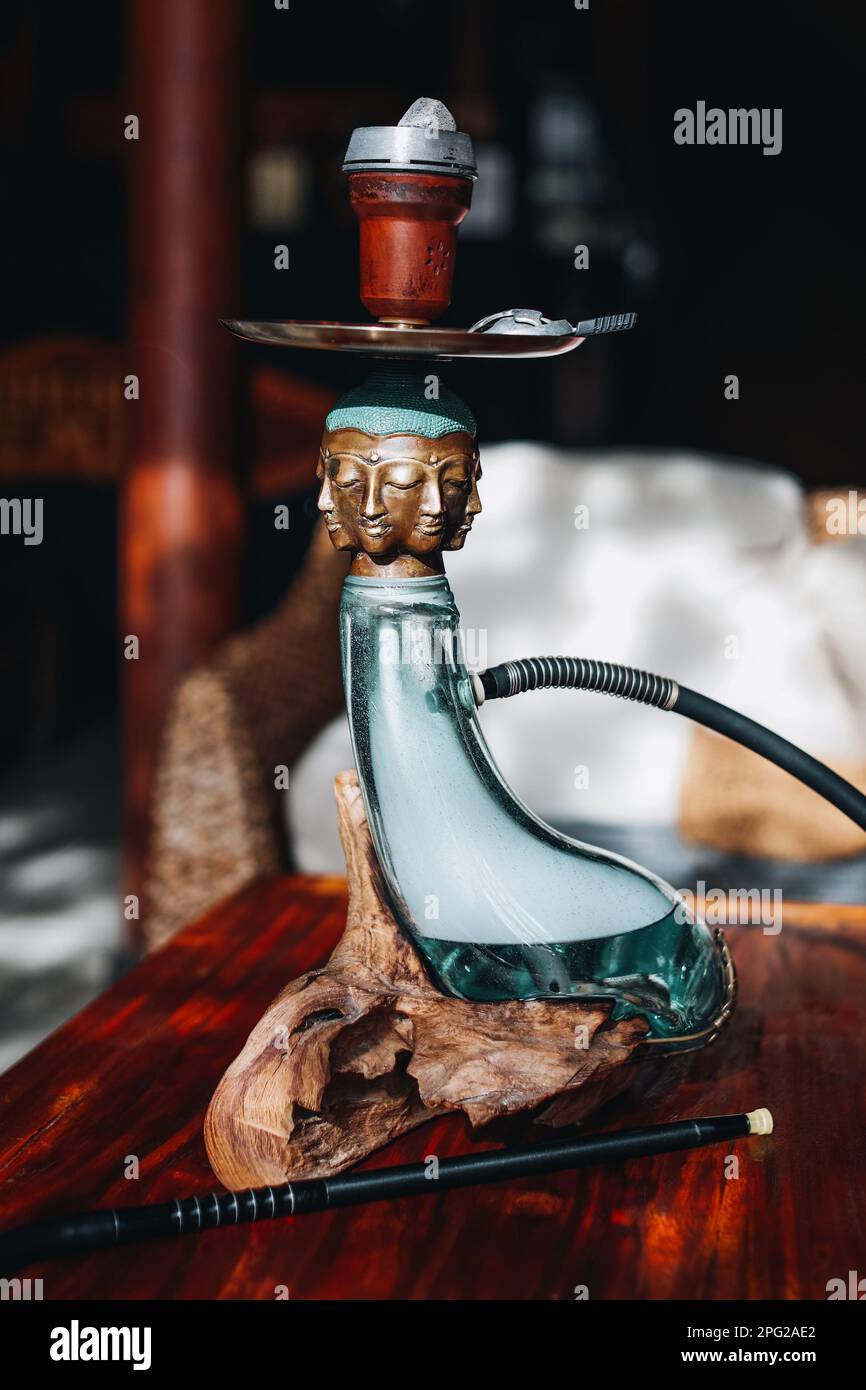 Creative rare exclusive golden buddha head hookah standing on a wooden