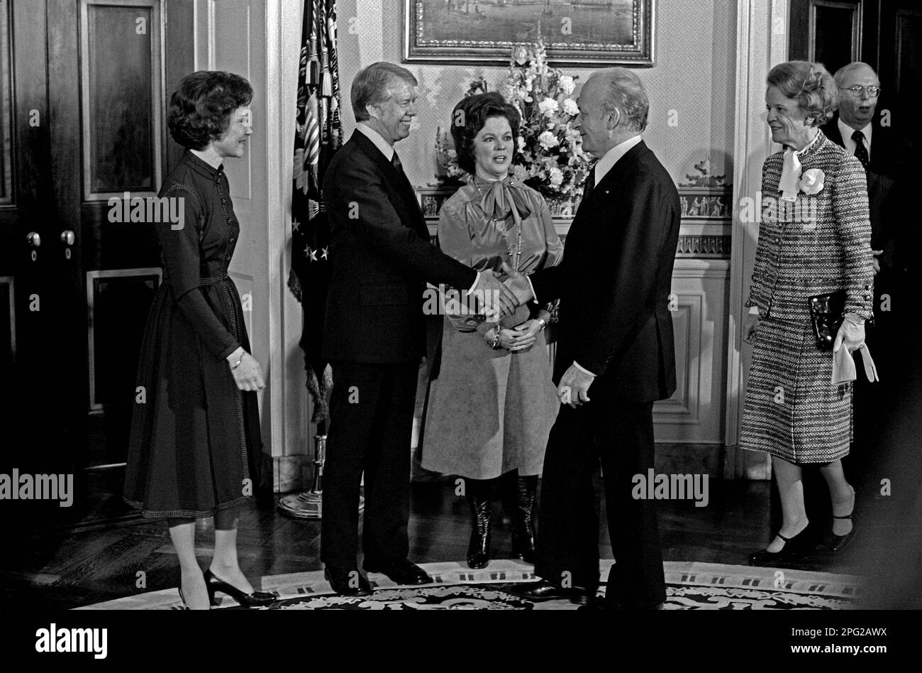 United States President Jimmy Carter, left center, welcomes Ambassador Jacques Kosciusco-Morizet of France, right center, in the Blue Room of the White House in Washington, DC on the first full day of the Carter-Mondale Administration on January 21, 1977. At center is Chief of Protocol of the US Shirley Temple Black. First lady Rosalynn Carter stands at left and Madame Morizet is at right.Credit: Barry A. Soorenko/CNP Stock Photo