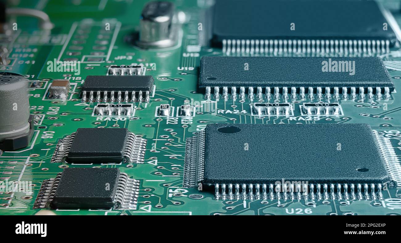 electronic circuit board with passive and active circuit components and IC close-up Stock Photo