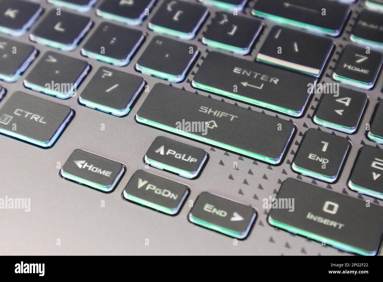 Arrow keys with illumination and selective focus. Gaming powerful grey notebook keyboard close-up. Tech, IT, electronics, computer science background Stock Photo