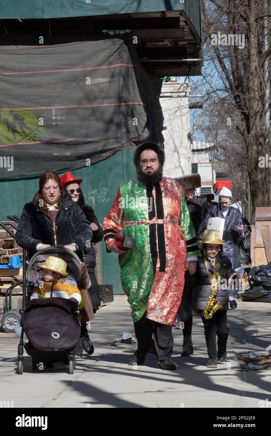A Hasidic family walk on Ross St. in Williamsburg, Brooklyn wearing their colorful Purim costumes Stock Photo