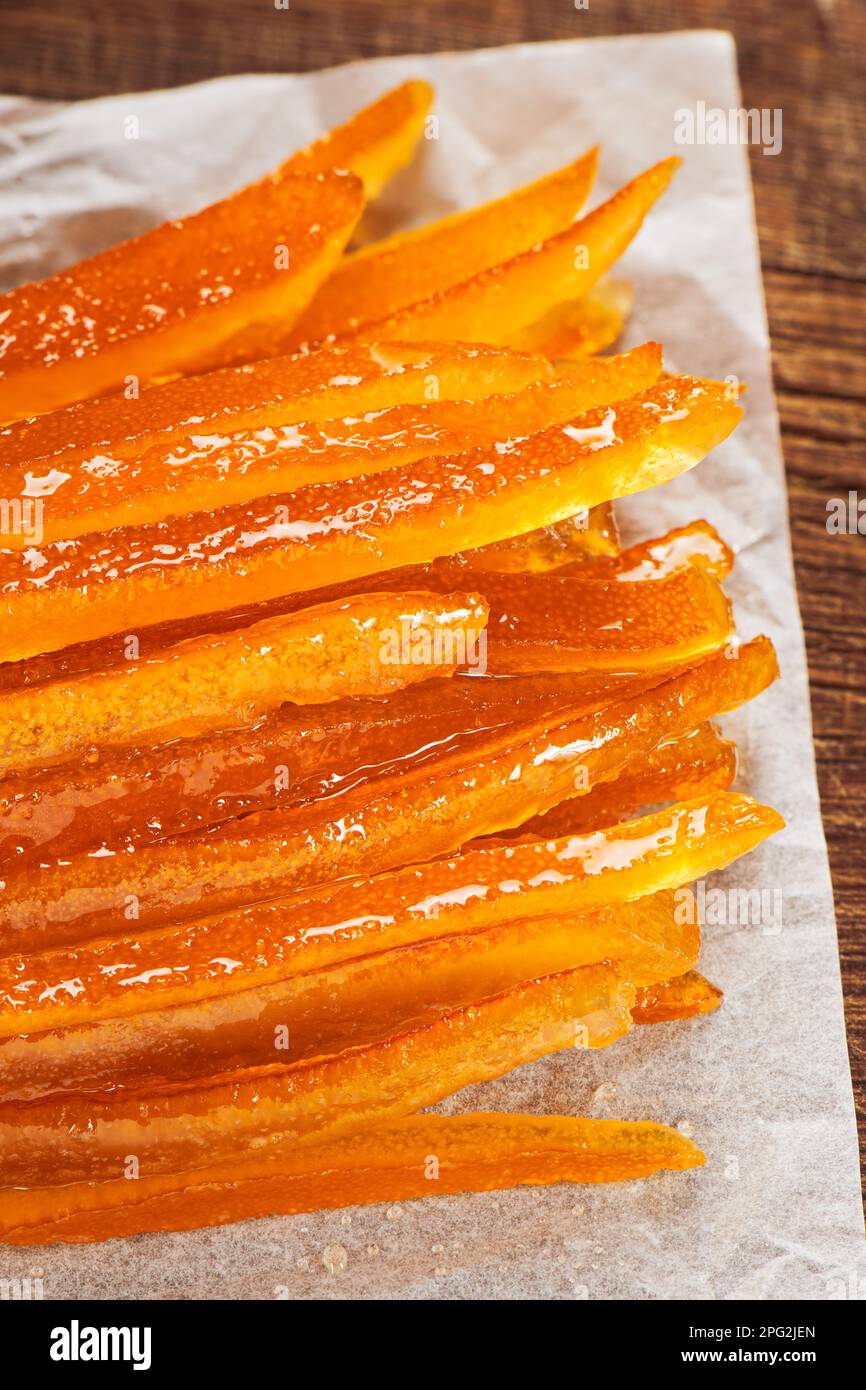 Candied orange peels on wrinkled baking paper. Stock Photo
