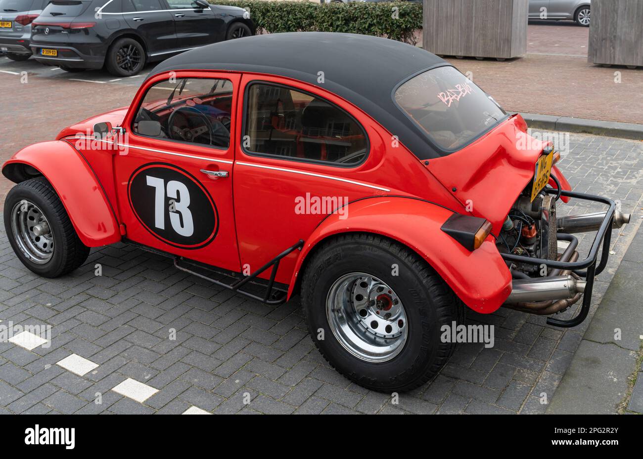 Noordwijk, The Netherlands, 19.03.2023, Rear-side view of custom off-road Volkswagen Beetle 1973 in red color Stock Photo