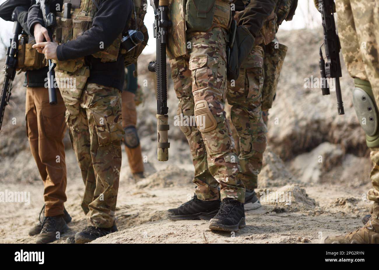 Group of Ukrainian soldiers wearing multicam camouflage clothing training on shooting range with
