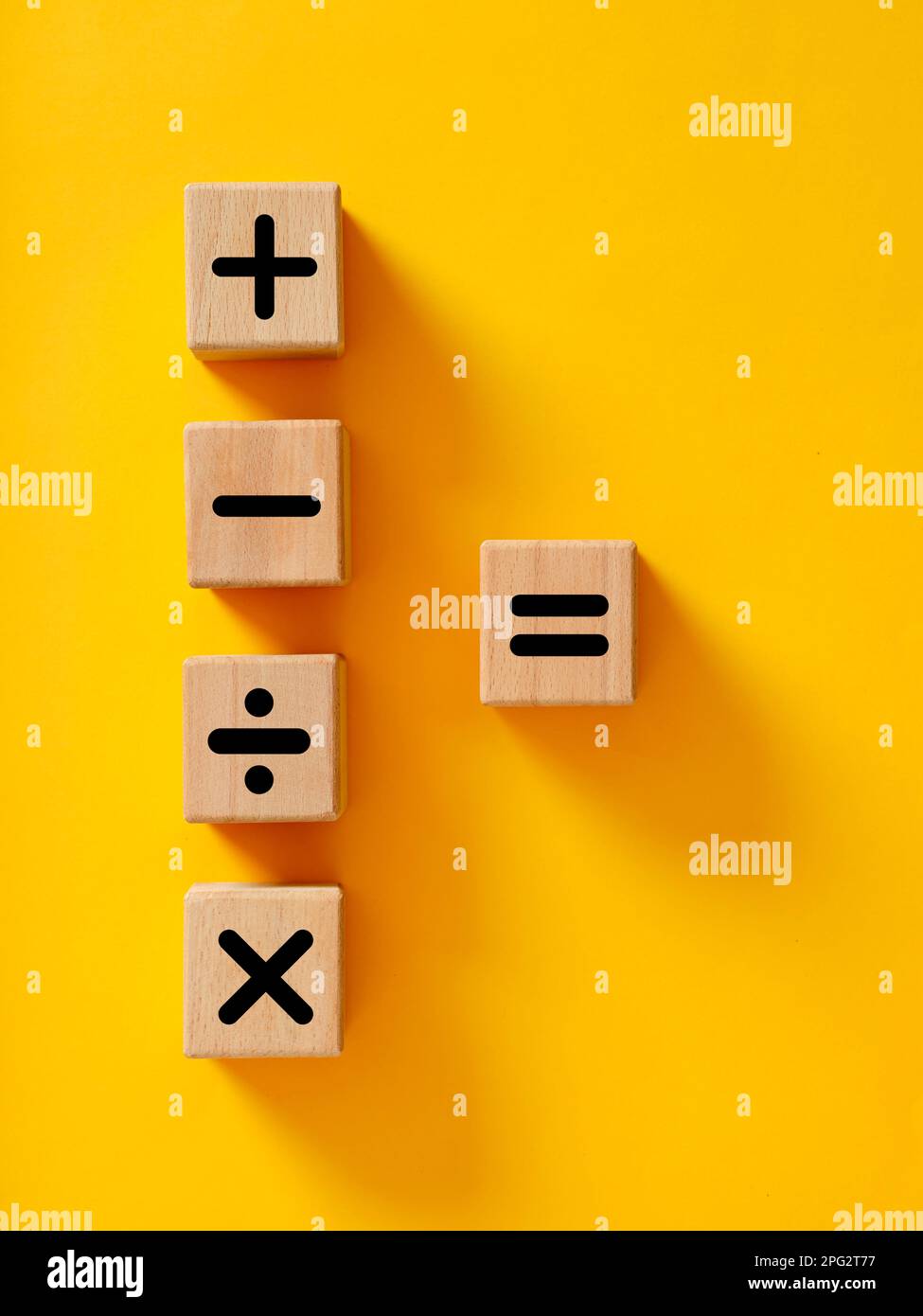 Basic mathematical operations symbols. Plus, minus, multiply, divide and equal symbols on wooden cubes. Mathematic or math education and basic calcula Stock Photo