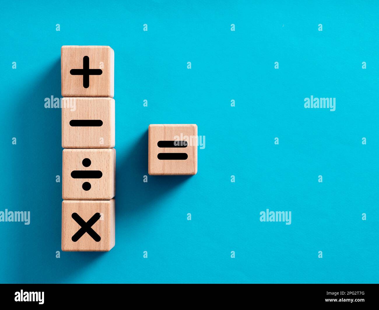 Basic mathematical operations symbols. Plus, minus, multiply, divide and equal symbols on wooden cubes. Mathematic or math education and basic calcula Stock Photo