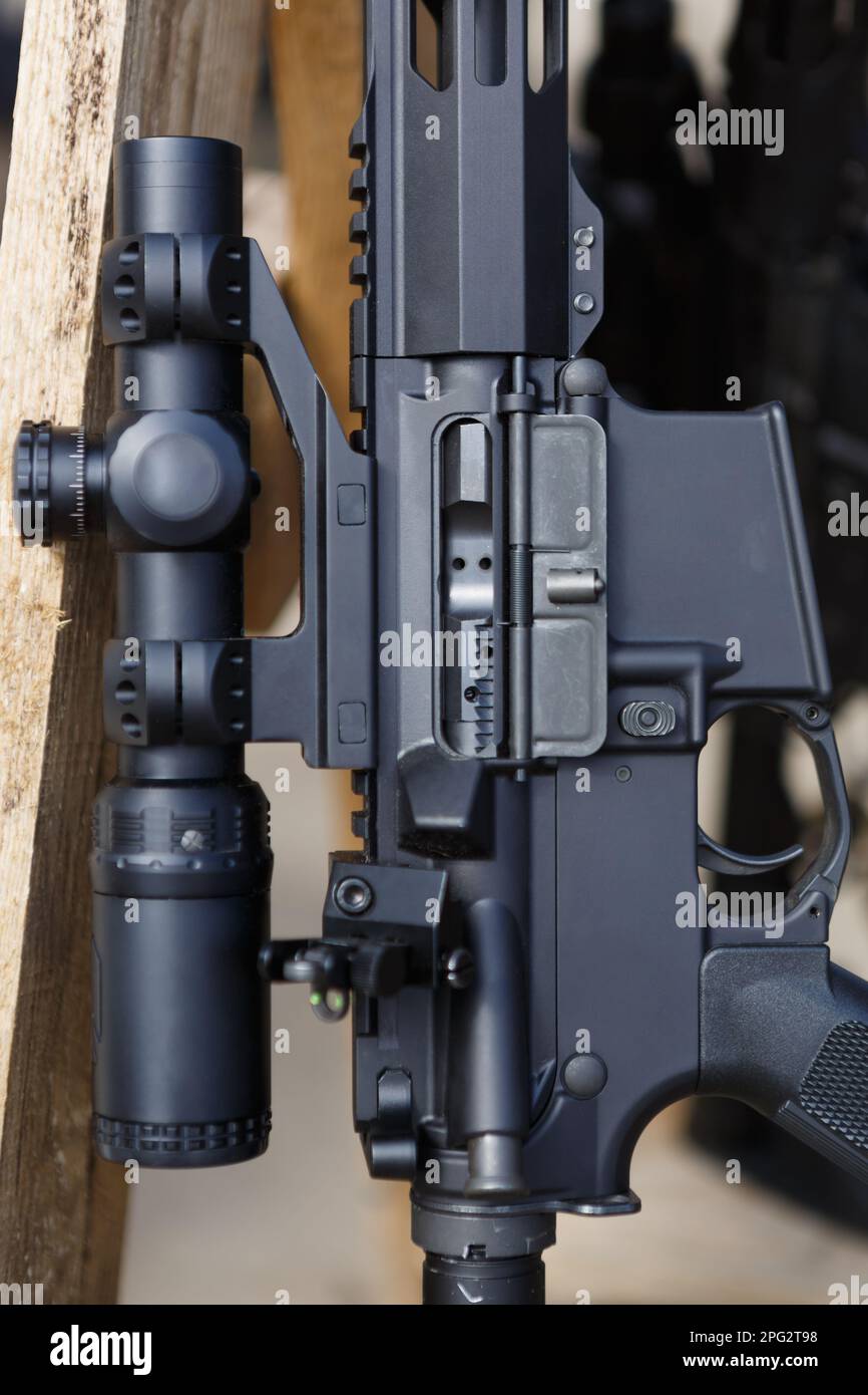 Black 5.56mm assault rifle with optical scope. Modern American weapon
