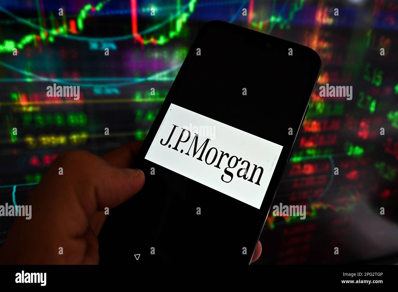 In this photo illustration, a JP Morgan logo is displayed on a smartphone  with stock market percentages on the background Stock Photo - Alamy