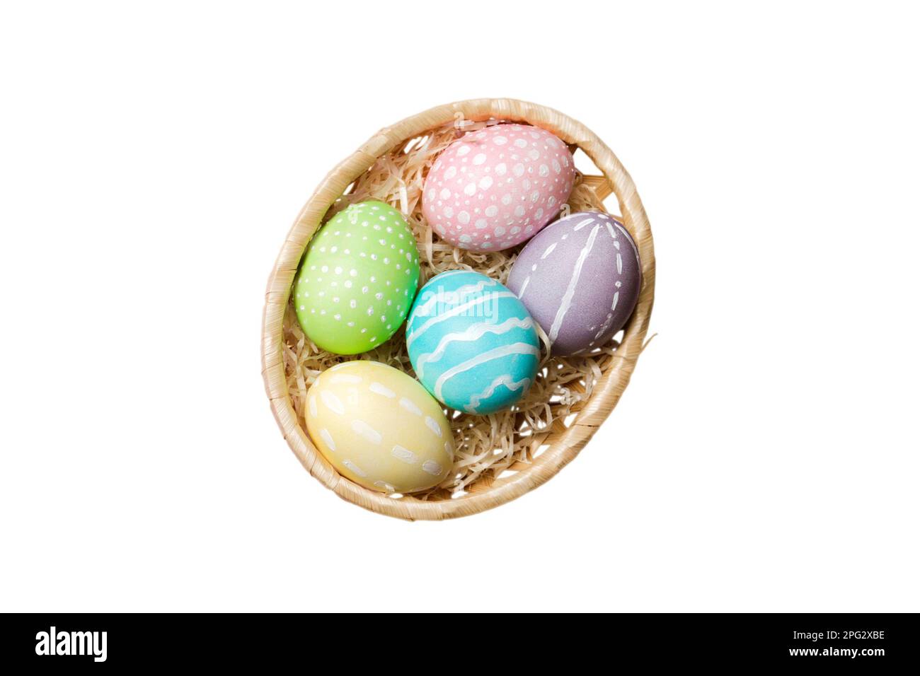 Basket of colorful Easter eggs isolated on white background. Easter basket filled with colored eggs top view holiday concept . Stock Photo