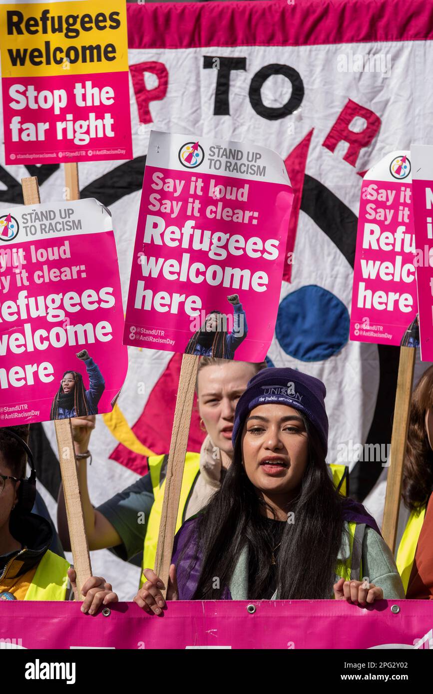 Protest taking place in London on UN Anti Racism Day. Stand up to Racism. Protesters and placards. Female protester Stock Photo