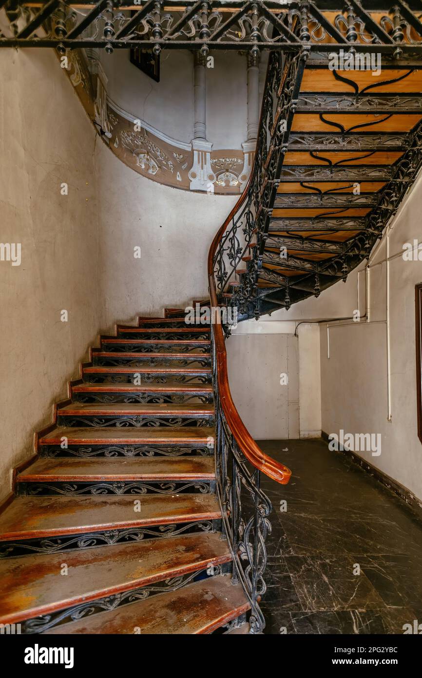 Vintage forged cast iron spiral staircase at the old mansion Stock