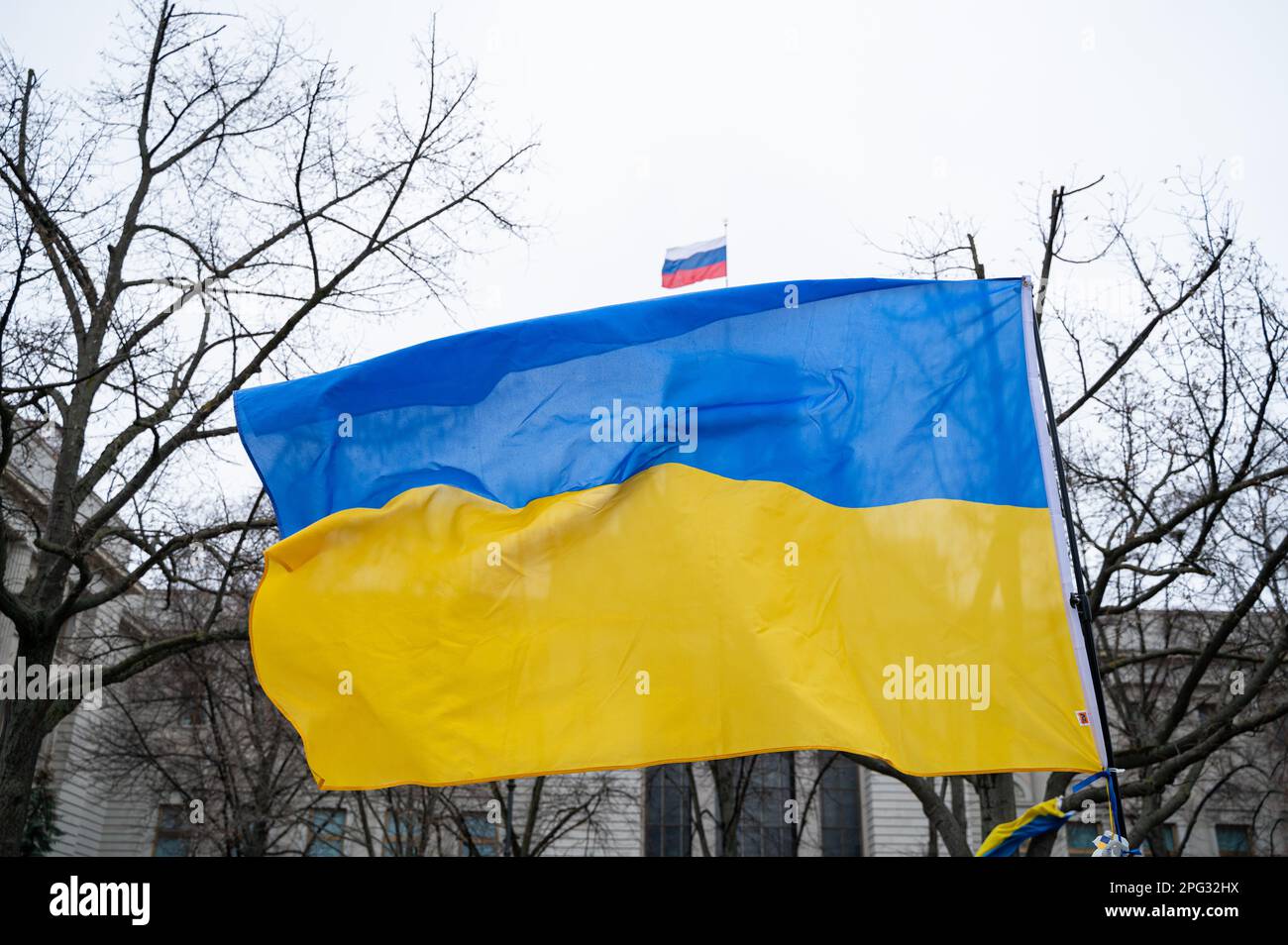 24.02.2023, Berlin, Germany, Europe - Ukrainian national flag waves in front of the Russian embassy on boulevard Unter den Linden in Mitte district. Stock Photo