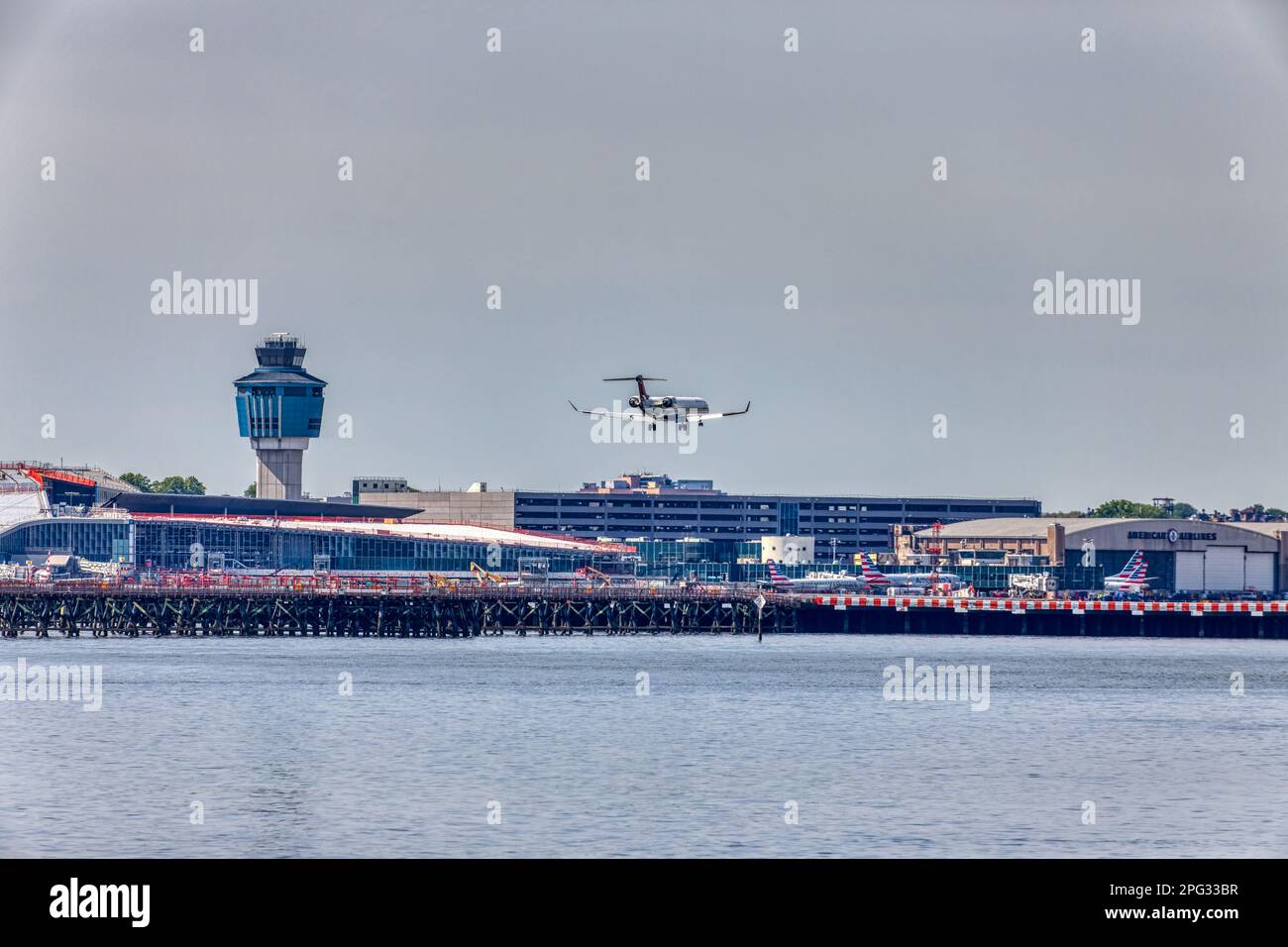 A Delta Connection Bombardier CRJ-900 twin-engine passenger jet approaches and lands at LaGuardia Airport runway 22 in East Elmhurst, Queens. Stock Photo