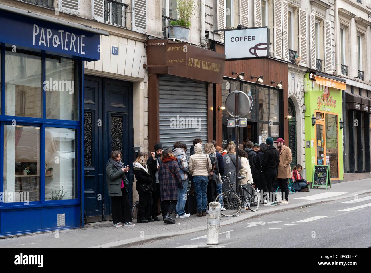 Customers queueing for coffee in trendy Rue des Martyrs in Paris, France Stock Photo