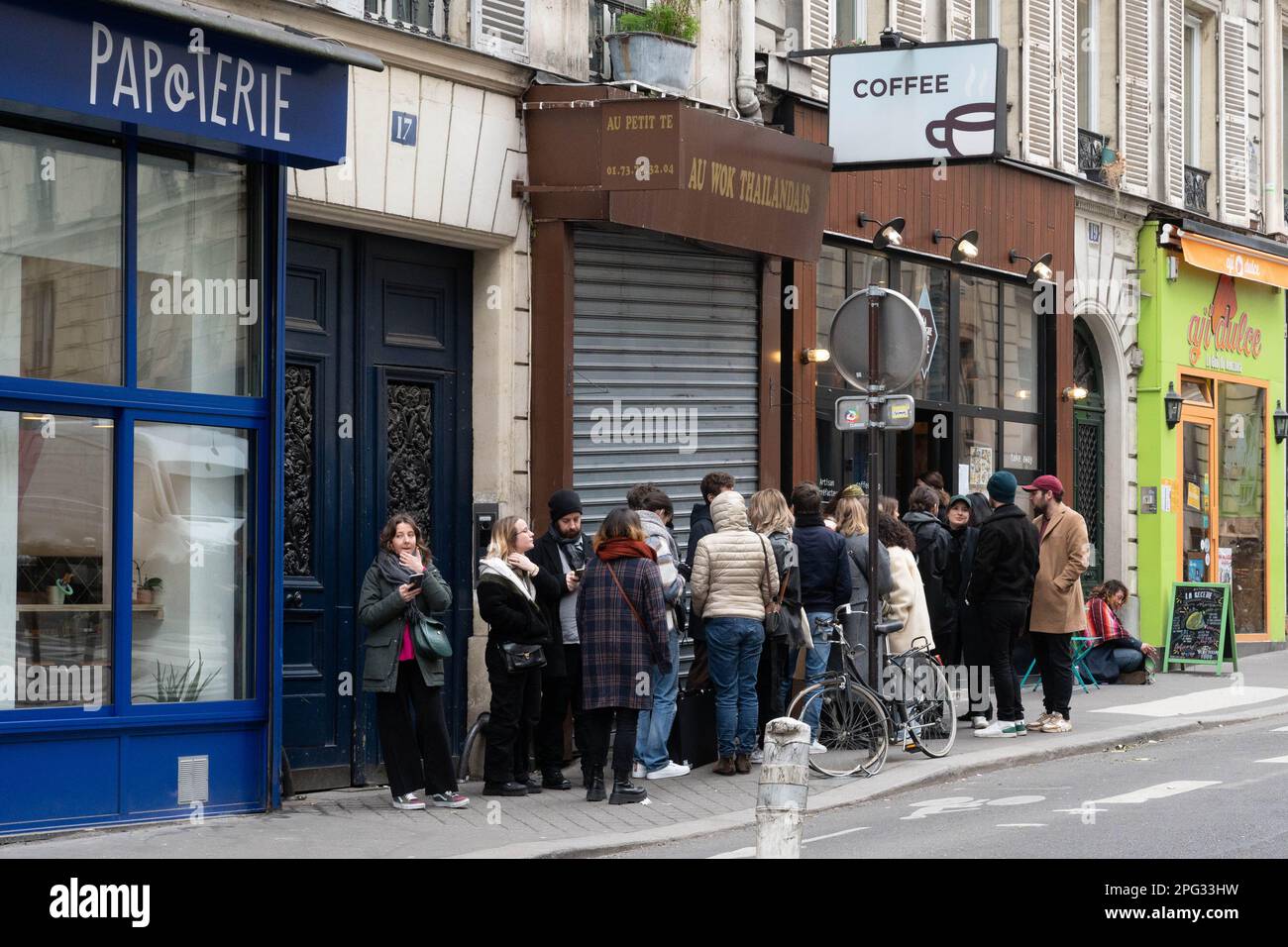 Customers queueing for coffee in trendy Rue des Martyrs in Paris, France Stock Photo