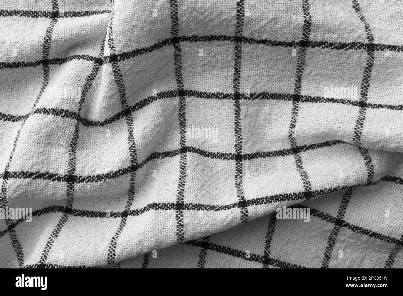 Classic black and white checkered kitchen towel texture. Crumpled