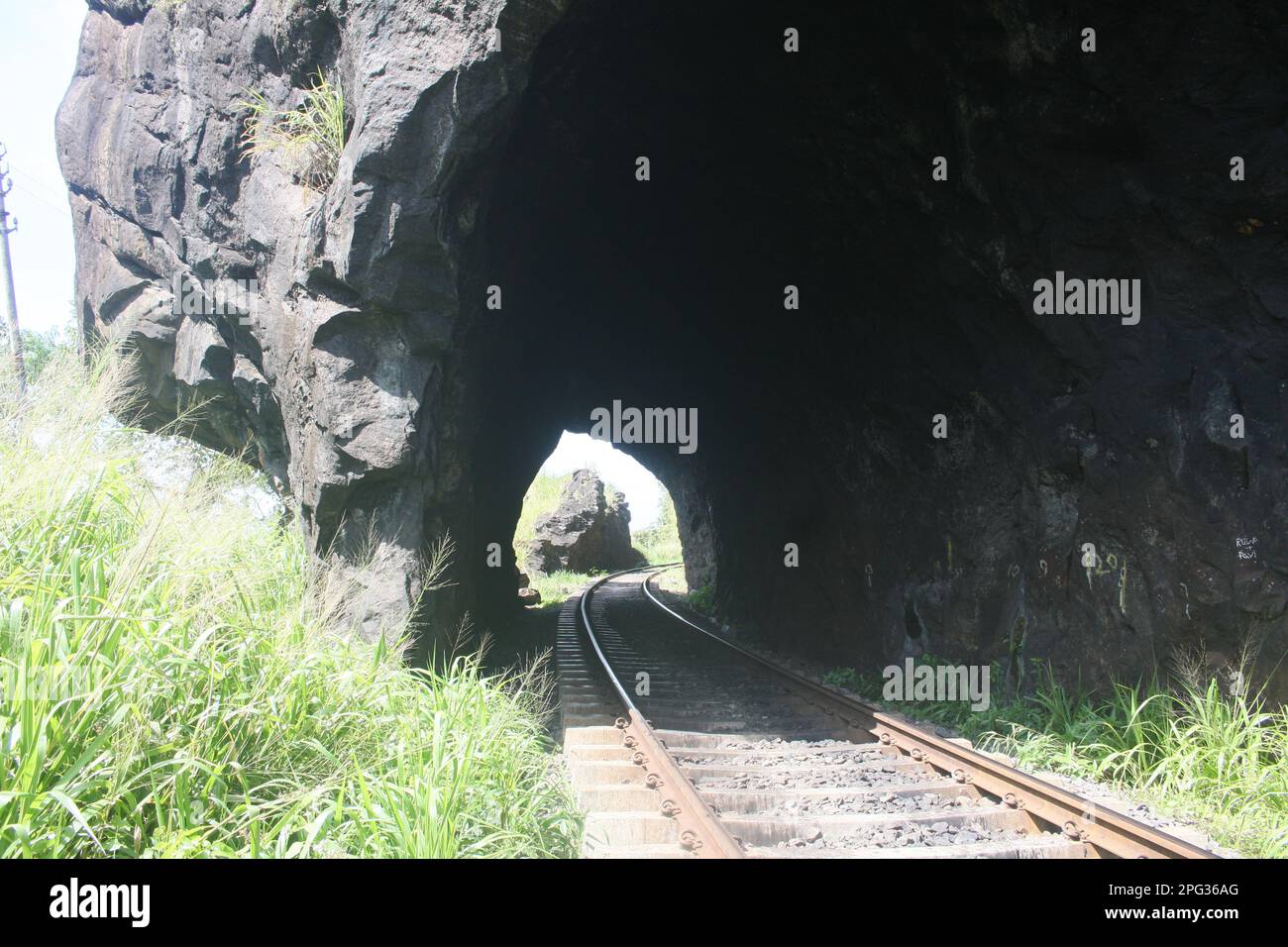 A rail tunnel is a type of tunnel specifically designed to accommodate railway tracks and allow trains to pass through. Stock Photo