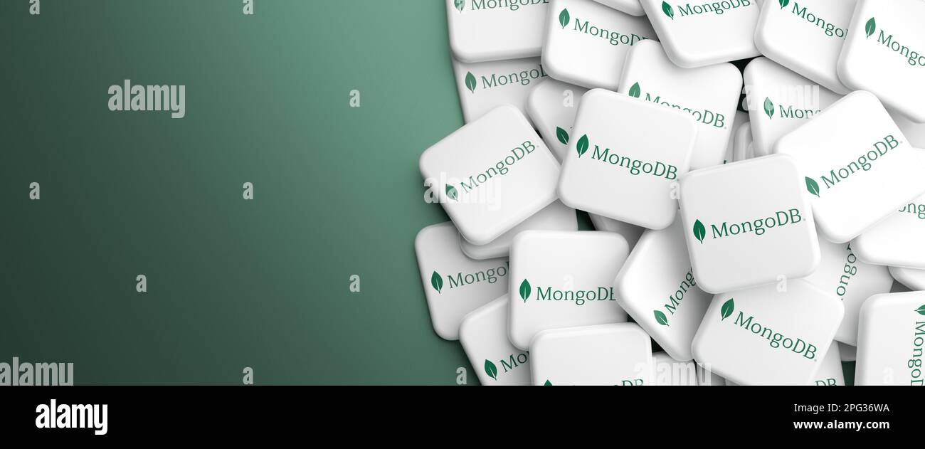 Logos of the source-available NoSQL database system MongoDB on a heap on a table. Web banner format, copy space. Stock Photo