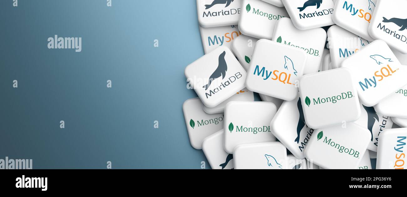 Logos of the open source / source available database systems MySQL, MariaDB and MongoDB on a heap on a table. Web banner format, copy space. Stock Photo