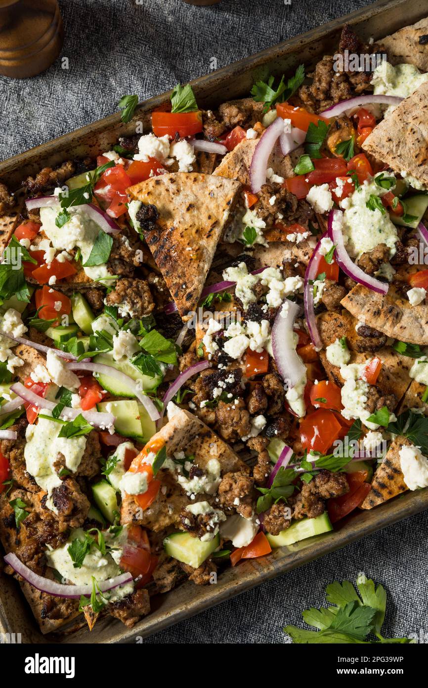Mediterranean Homemade Pita Nachos with Lamb Hummus Feta and Cucumber