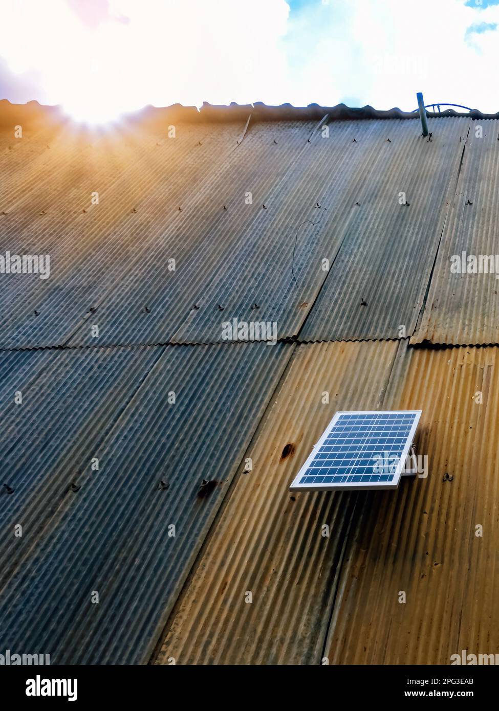 Solar panel attached on old zinc wall. Electric solar panel on the