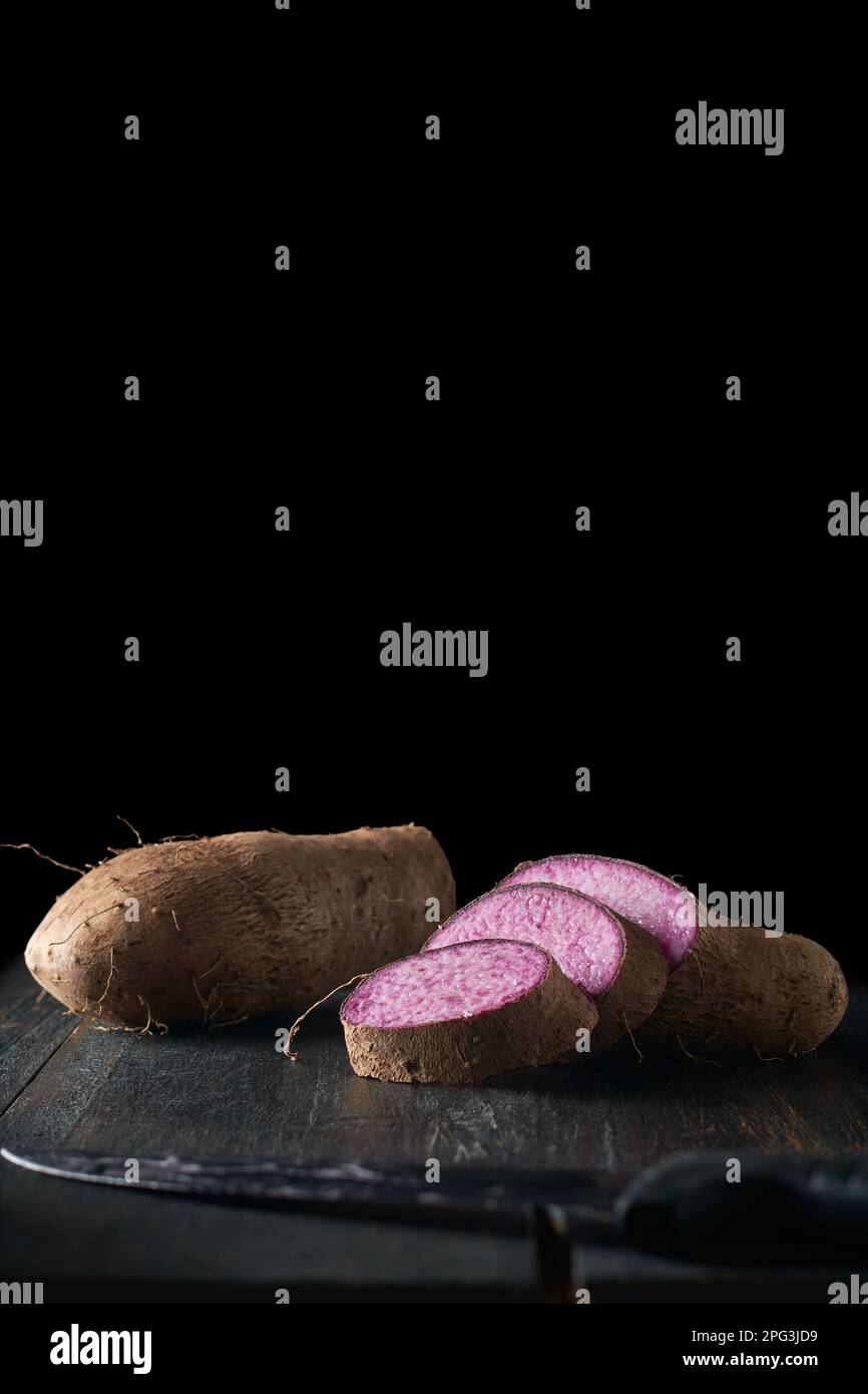sliced purple yam on table top, dioscorea alata, aka ube, violet yam, water or greater yam, purple-fleshed tubers used in cuisine Stock Photo