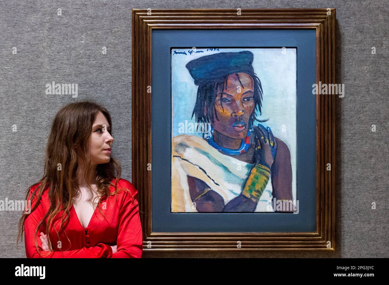London, UK.  20 March 2023. A staff member views ‘Young Pondo Man’, 1929, by Irma Stern (Est. £300,000 - £500,000) at a preview of Bonhams’ Modern & Contemporary African Art sale.  Works by some of the biggest names in South African Art are to be auctioned at Bonhams New Bond Street galleries on 22 March.  Credit: Stephen Chung / Alamy Live News Stock Photo