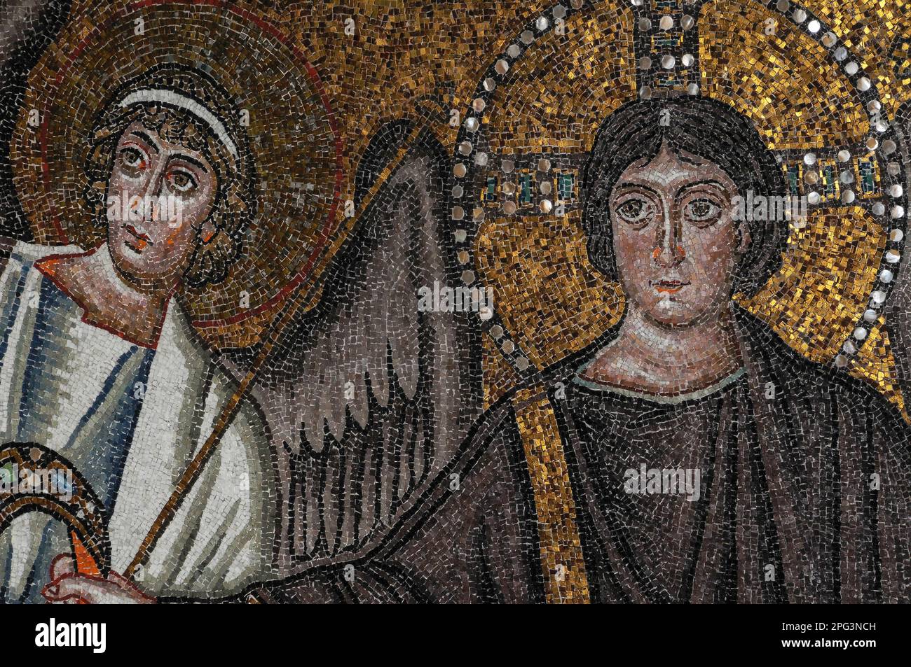 Christ the Redeemer, depicted as young, beardless and flanked by an archangel against a background of golden tesserae and inlaid mother of pearl: 6th century AD Byzantine mosaic in the apse dome of the Basilica di San Vitale, founded in 547 AD at Ravenna, Emilia Romagna, Italy. Stock Photo
