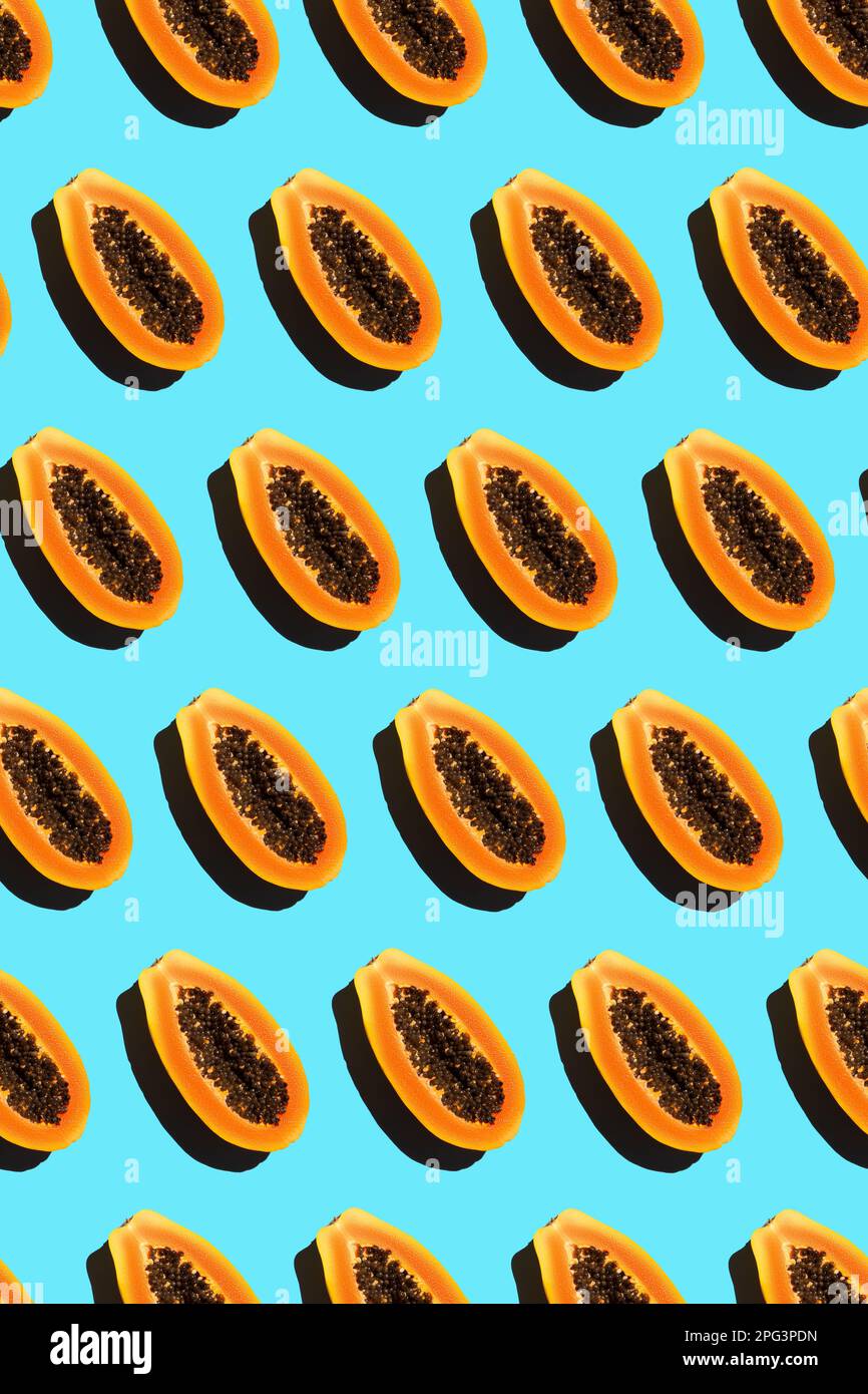solid pattern of halves of ripe orange papayas with black seeds Stock Photo