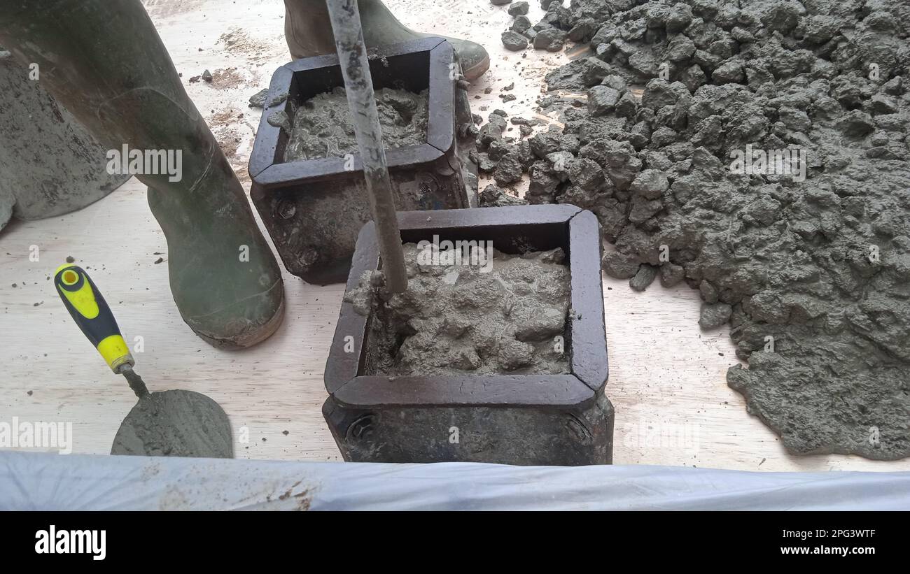 Sampling of concrete cubes at field construction sites to check