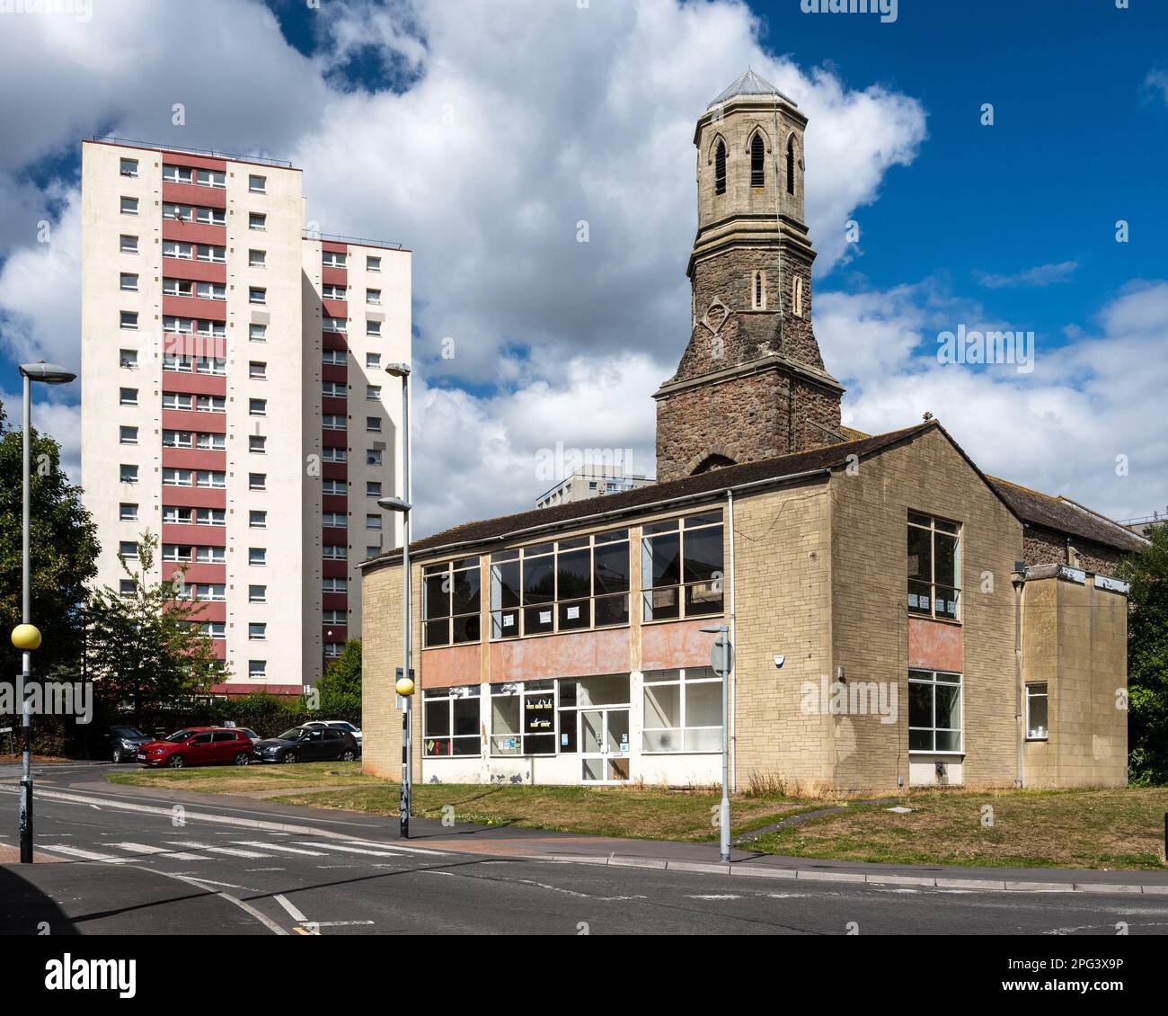 Harwood House high rise tower block stands behind St Luke's Church and community hall on the Barton Hill Estate in Bristol. Stock Photo