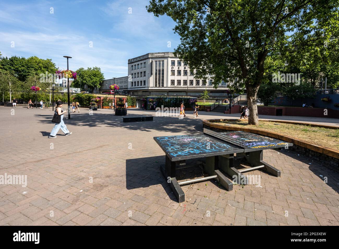 Pedestrians walk past a ping pong table in 'The Bearpit', a sunken plaza within St James Barton Roundabout in Bristol. Stock Photo
