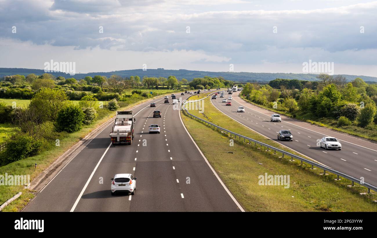 Traffic flows on the M5 motorway across the North Somerset Levels, with the Mendip Hills in the distance. Stock Photo
