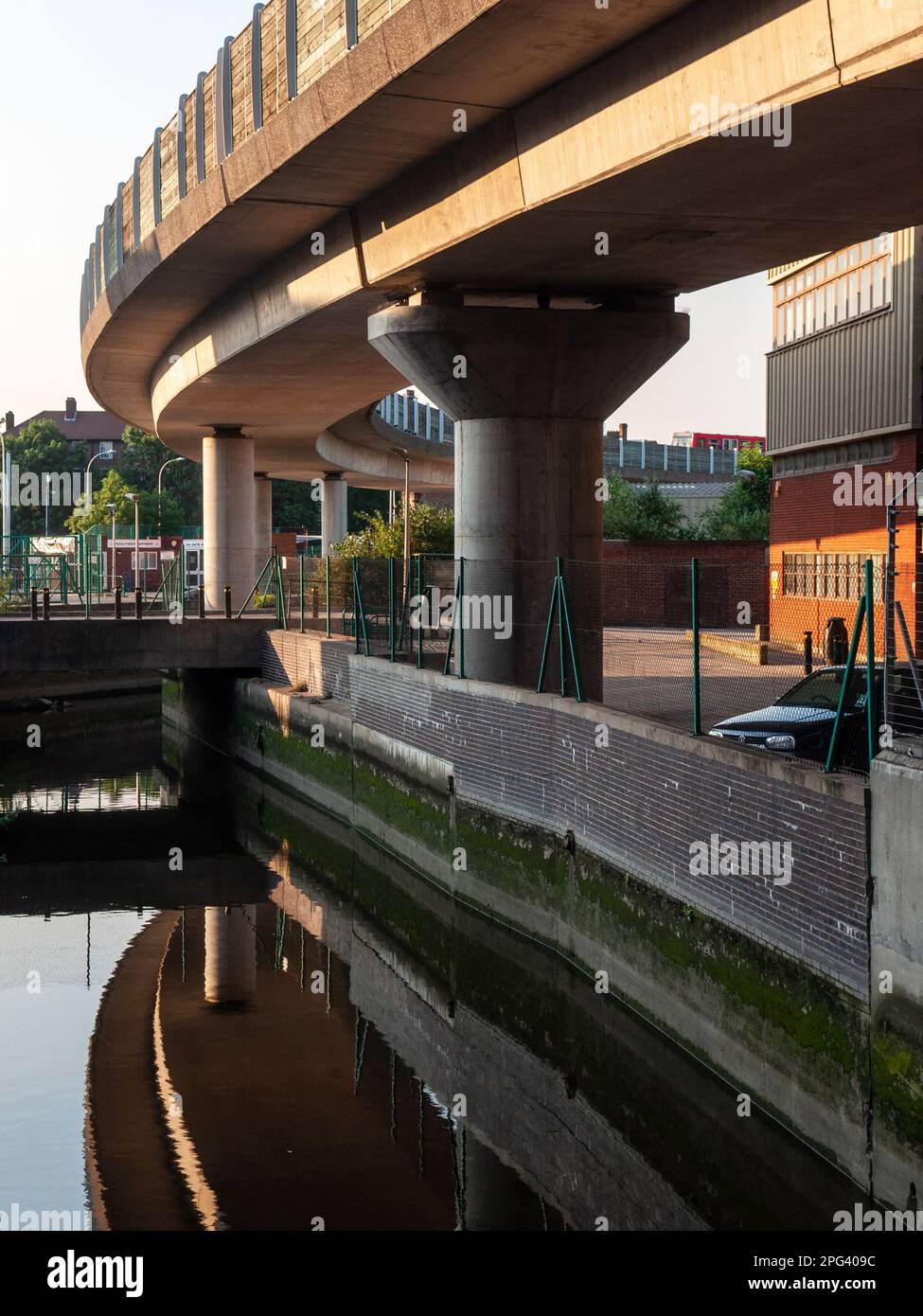 London, England, UK - June 26, 2010: Evening sun shines on the elevated viaduct carrying the Docklands Light Railway at Deptford Bridge above the Dept Stock Photo