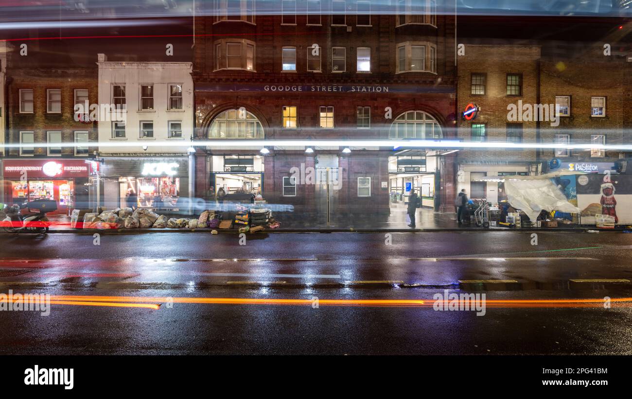 Goodge Street Station is seen through the lights of passing traffic on Tottenham Court Road in central London. Stock Photo