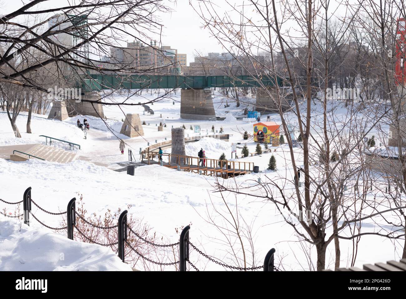 People enjoying the outdoors in winter at the  Arctic Glacier Winter Park at The Forks on the Assiniboine River in Winnipeg, Manitoba, Canada. Stock Photo