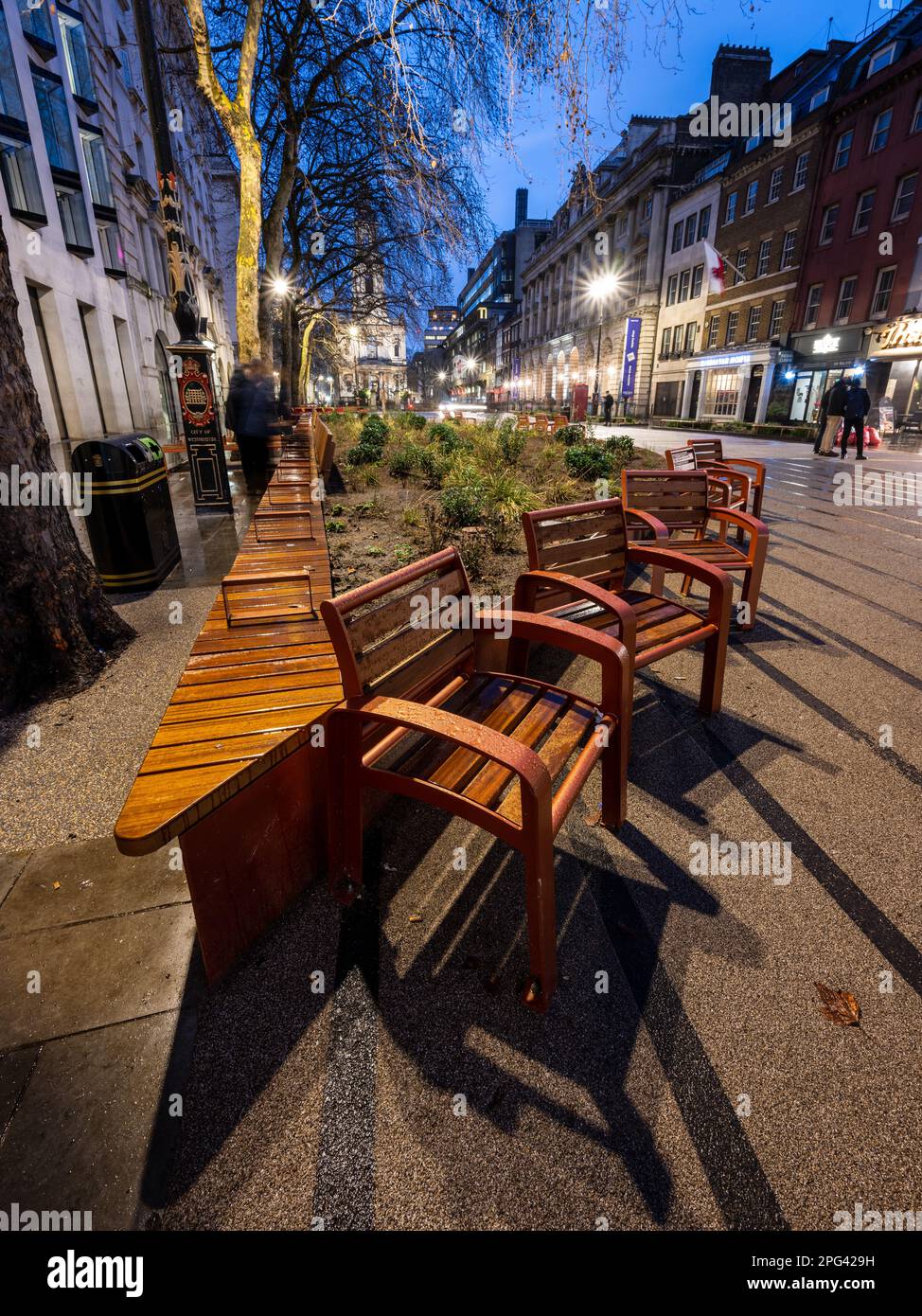 Outdoor seating is arranged around a large flower border on the recently pedestrianised Strand, a once busy street in central London. Stock Photo