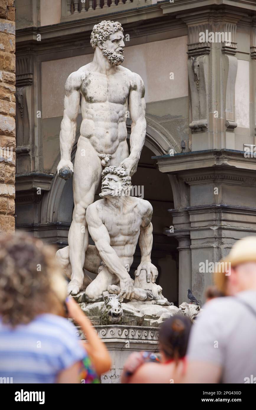 People looking at statue of Hercules and Cacus, Piazza della Signoria, Florence, Italy Stock Photo