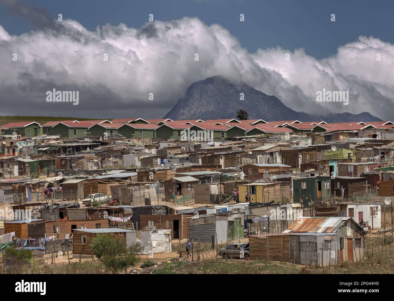 An informal settlement grows on a hill outside the Overberg town of Caledon. Above this is a new low-cost government RGP housing scheme ( RDP - Recons Stock Photo