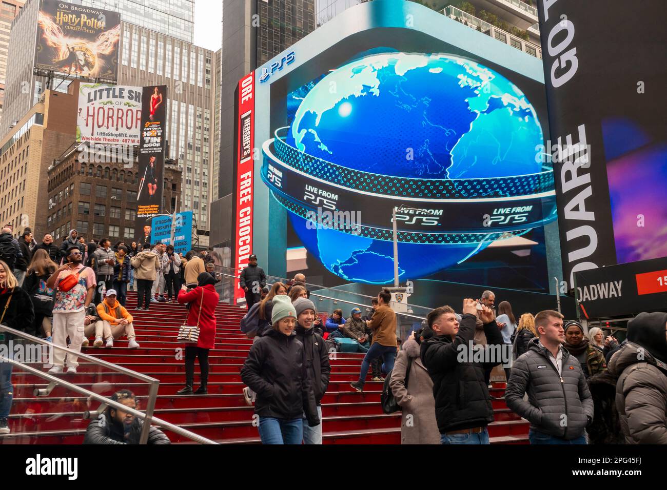 Tourists on the “Red Steps” in Times Square in New York seen on Sunday, March 12, 2023. (© Richard B. Levine) Stock Photo