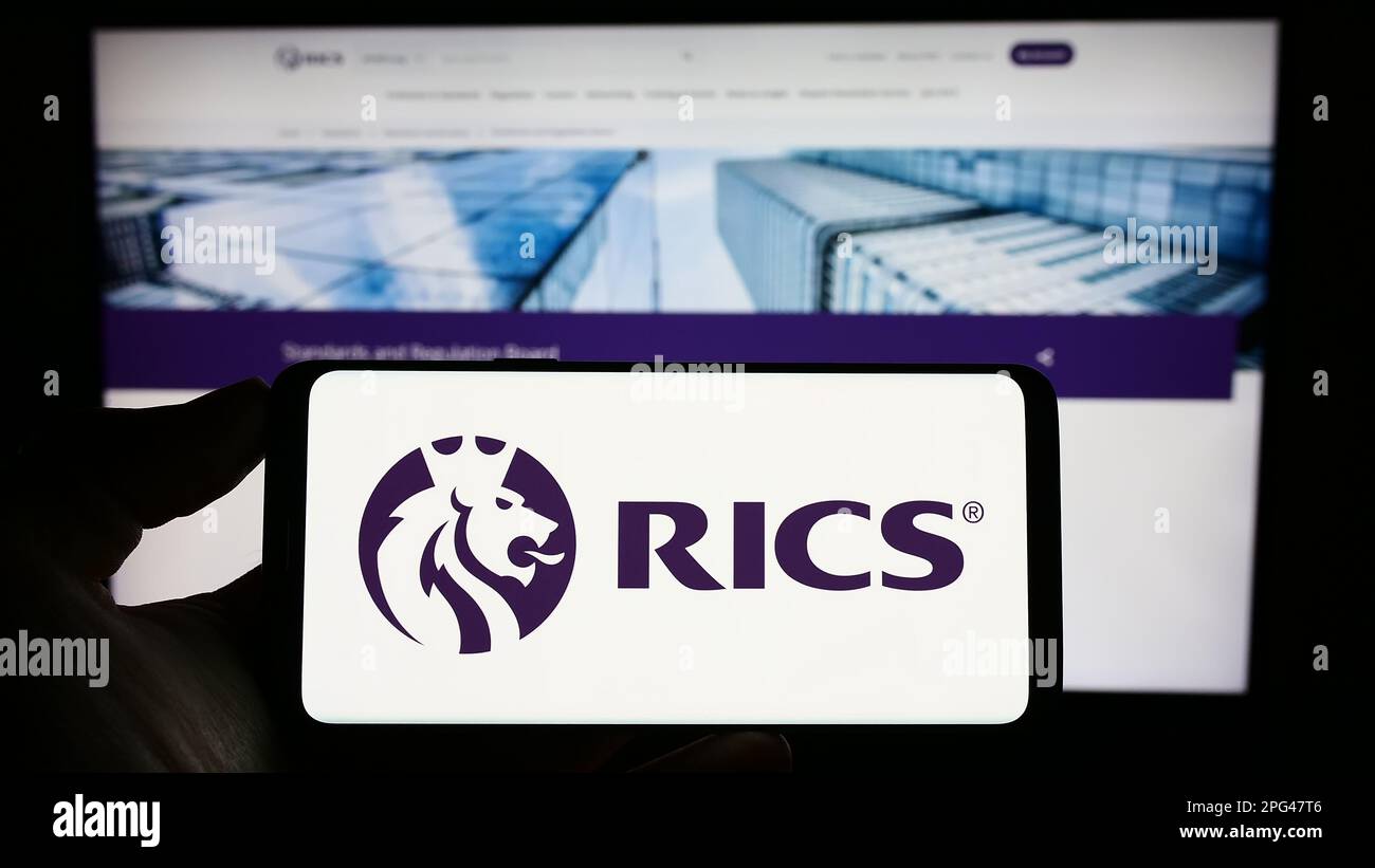 Person holding cellphone with logo of Royal Institution of Chartered ...