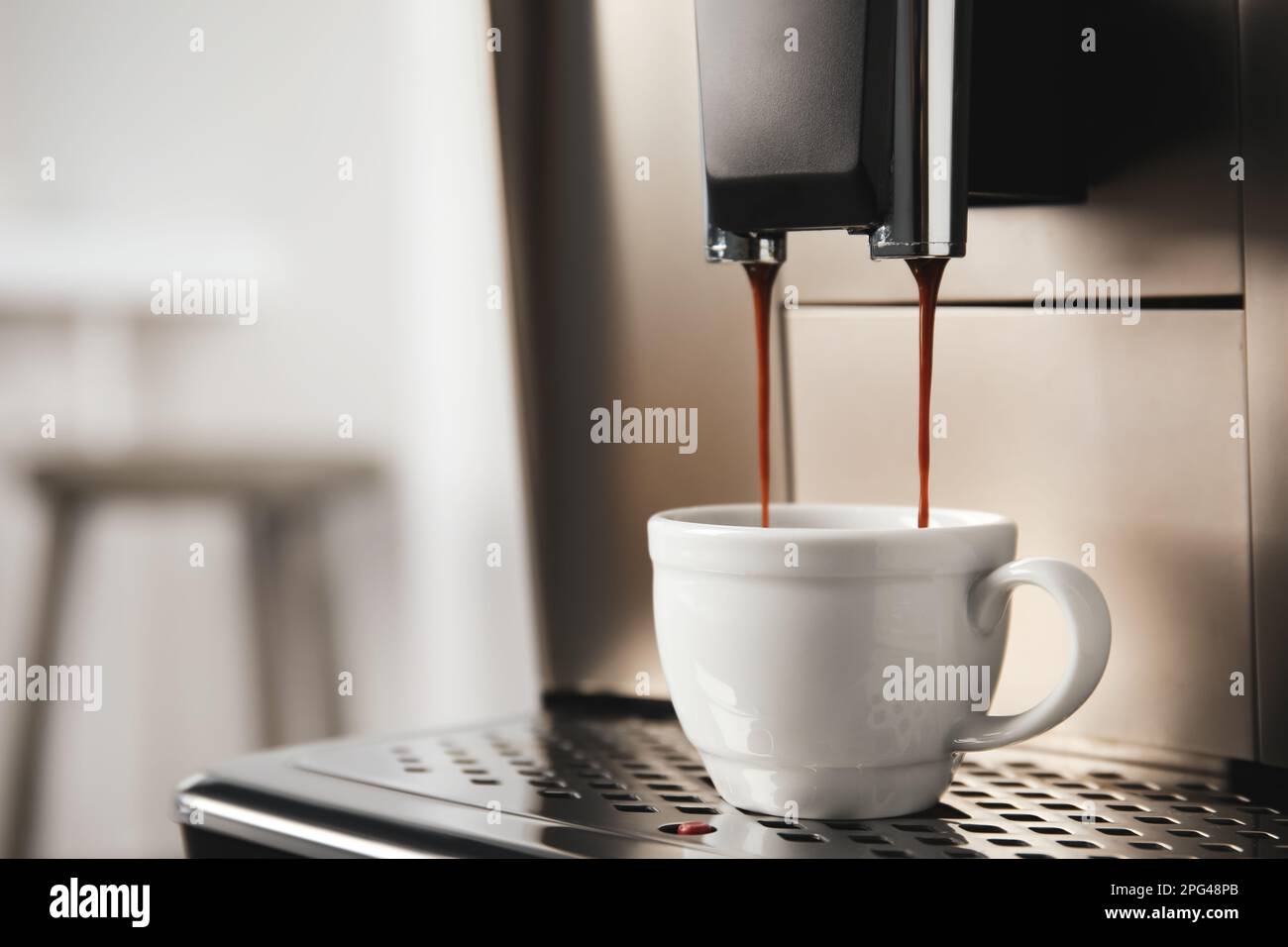 https://c8.alamy.com/comp/2PG48PB/espresso-machine-pouring-coffee-into-cup-against-blurred-background-closeup-space-for-text-2PG48PB.jpg