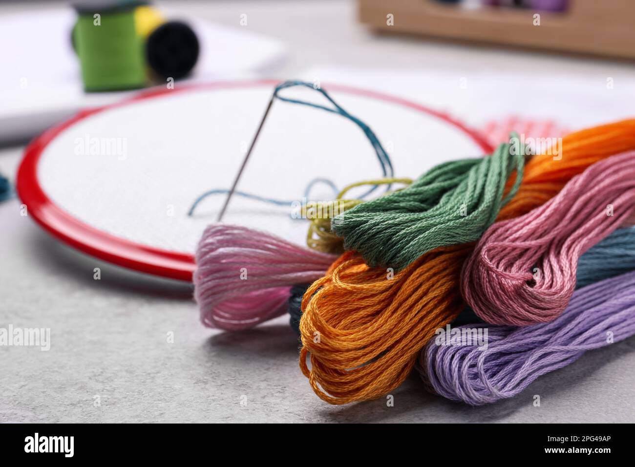 Thread Hoop Different threads and embroidery hoop on light grey table Stock Photo ...