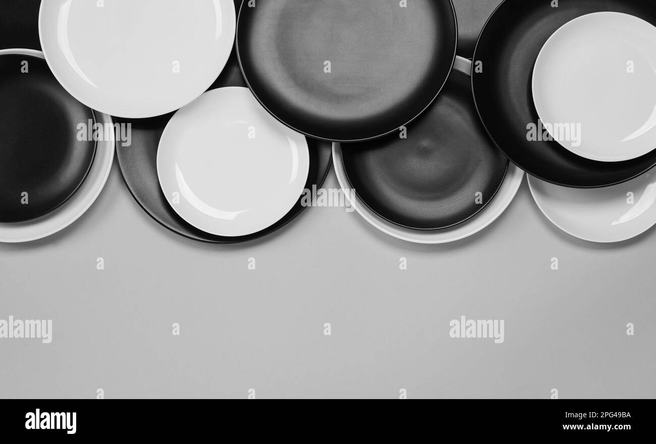 Different plates on light grey background, flat lay. Space for text ...
